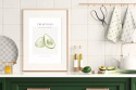 Aranżacja kuchni. Plakat oprawiony w ramkę na blacie kuchennym przedstawiający owoc avocado z napisem The kitchen avokado