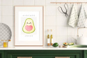 Aranżacja kuchni. Plakat oprawiony w ramkę na blacie kuchennym przedstawiający owoc avocado z serduszkiem.